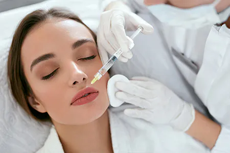 Close up of a patient receiving treatment of lip filling in Turkey, showcasing the process.